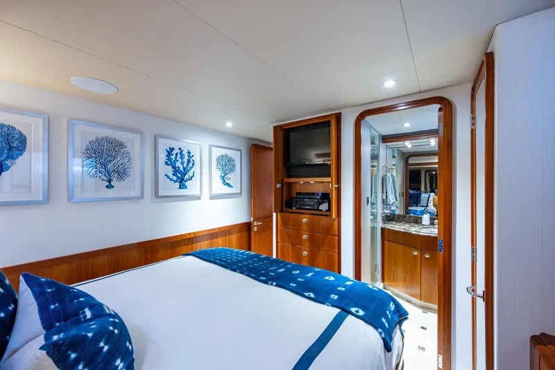 Lila Cuy Yacht Photos Pics Luxurious 2006 Westport w112 yacht bedroom with blue decor and ensuite bathroom.