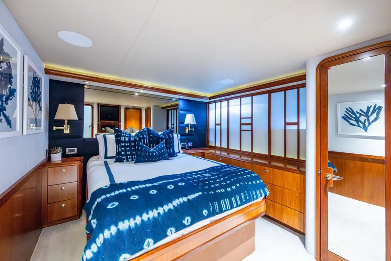 Lila Cuy Yacht Photos Pics Luxurious 2006 Westport w112 yacht bedroom with elegant blue decor and wooden accents.