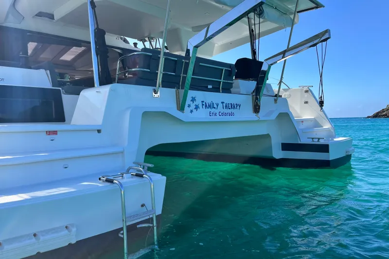 Family Therapy Yacht Photos Pics 2023 Fountaine Pajot Elba 45 Catamaran on turquoise water, rear view.