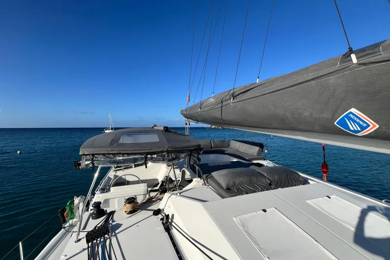 Family Therapy Yacht Photos Pics 2023 Fountaine Pajot Elba 45 Catamaran sailing on clear blue ocean.