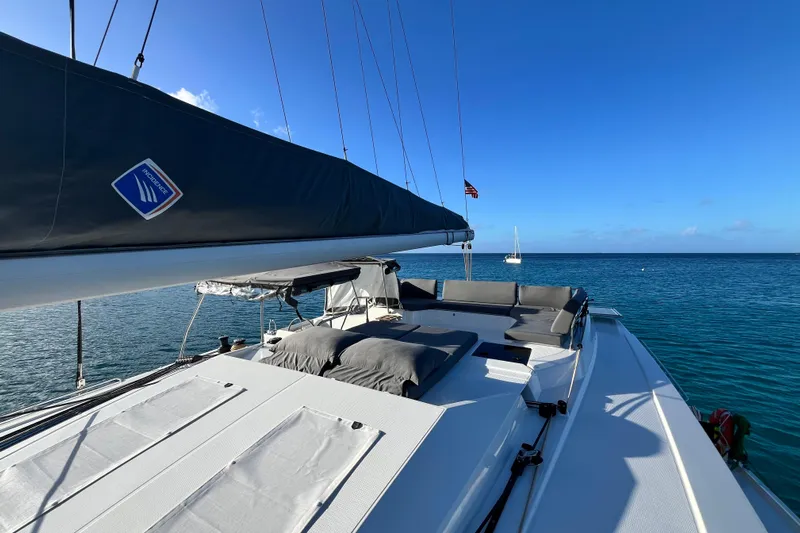 Family Therapy Yacht Photos Pics 2023 Fountaine Pajot Elba 45 Catamaran on serene ocean, featuring spacious deck and seating.