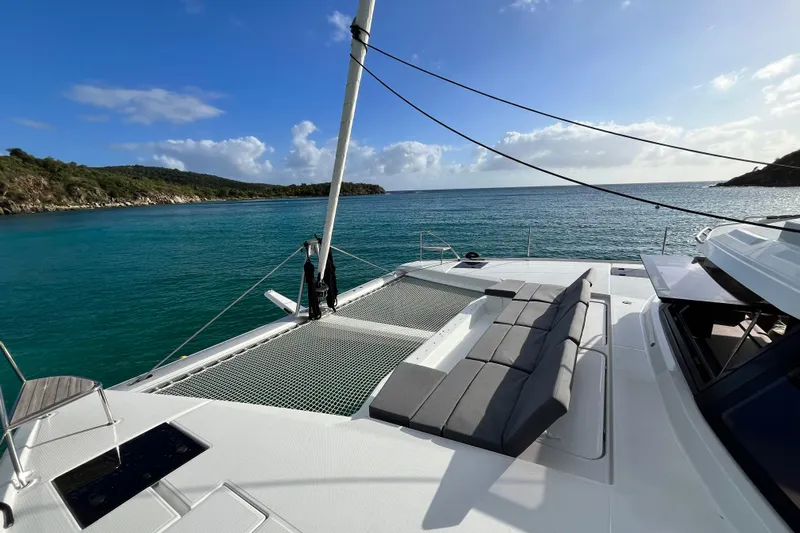 Family Therapy Yacht Photos Pics 2023 Fountaine Pajot Elba 45 Catamaran on serene blue waters, featuring spacious deck seating.