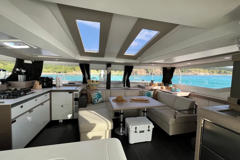 Family Therapy Yacht Photos Pics Luxurious interior of 2023 Fountaine Pajot Elba 45 Catamaran with scenic ocean view.