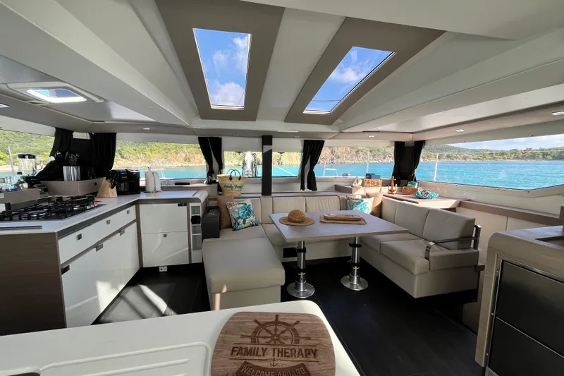 Family Therapy Yacht Photos Pics Luxurious interior of 2023 Fountaine Pajot Elba 45 Catamaran with scenic ocean view.