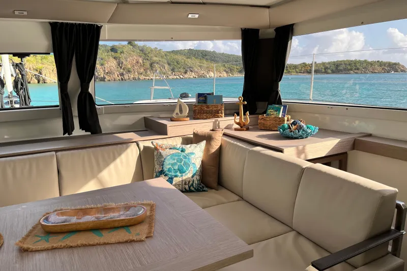 Family Therapy Yacht Photos Pics Luxurious interior of 2023 Fountaine Pajot Elba 45 Catamaran with scenic ocean view.