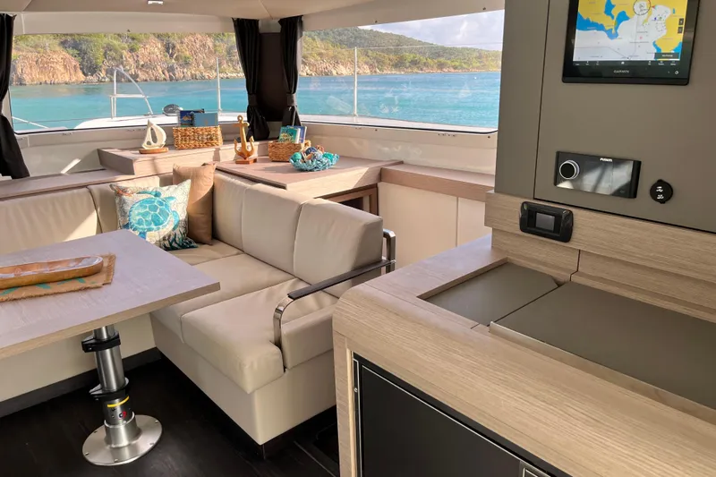 Family Therapy Yacht Photos Pics Luxurious interior of 2023 Fountaine Pajot Elba 45 Catamaran with ocean view.