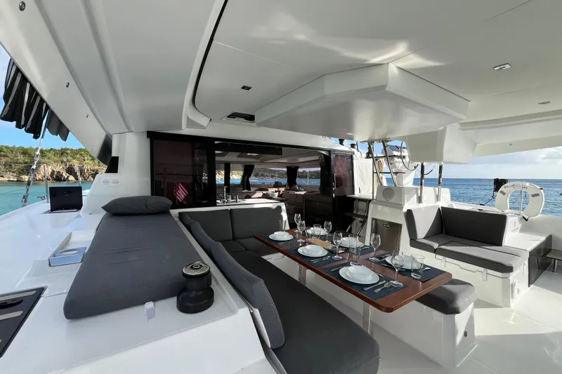 Family Therapy Yacht Photos Pics Luxurious 2023 Fountaine Pajot Elba 45 Catamaran with elegant outdoor dining area.