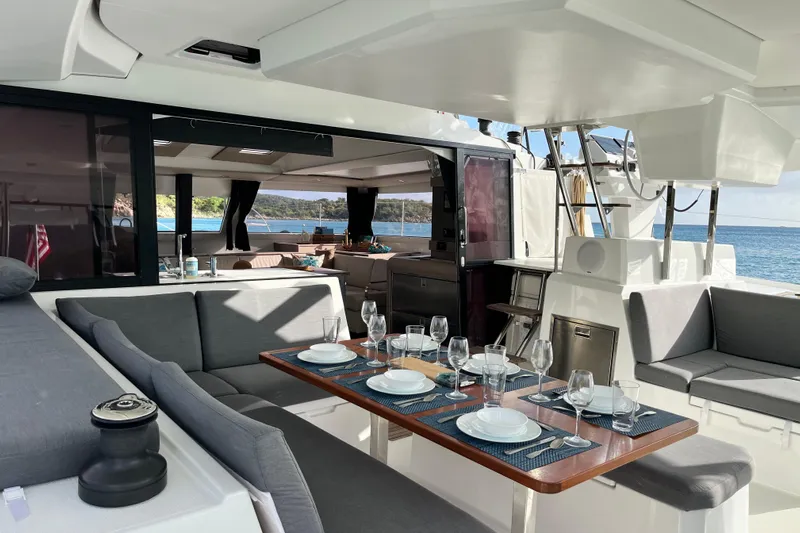 Family Therapy Yacht Photos Pics Luxurious 2023 Fountaine Pajot Elba 45 Catamaran with elegant outdoor dining setup.