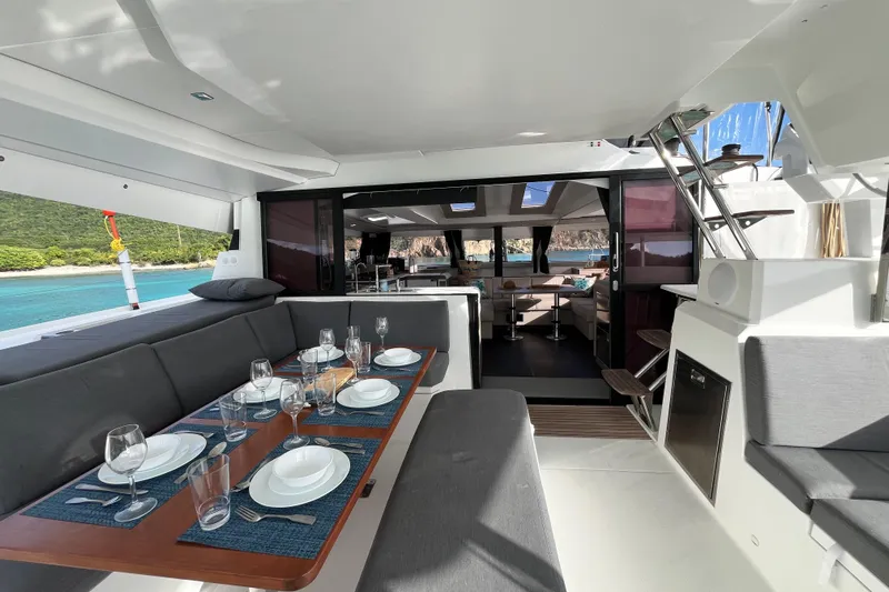 Family Therapy Yacht Photos Pics Luxurious 2023 Fountaine Pajot Elba 45 Catamaran with elegant dining setup and scenic ocean view.