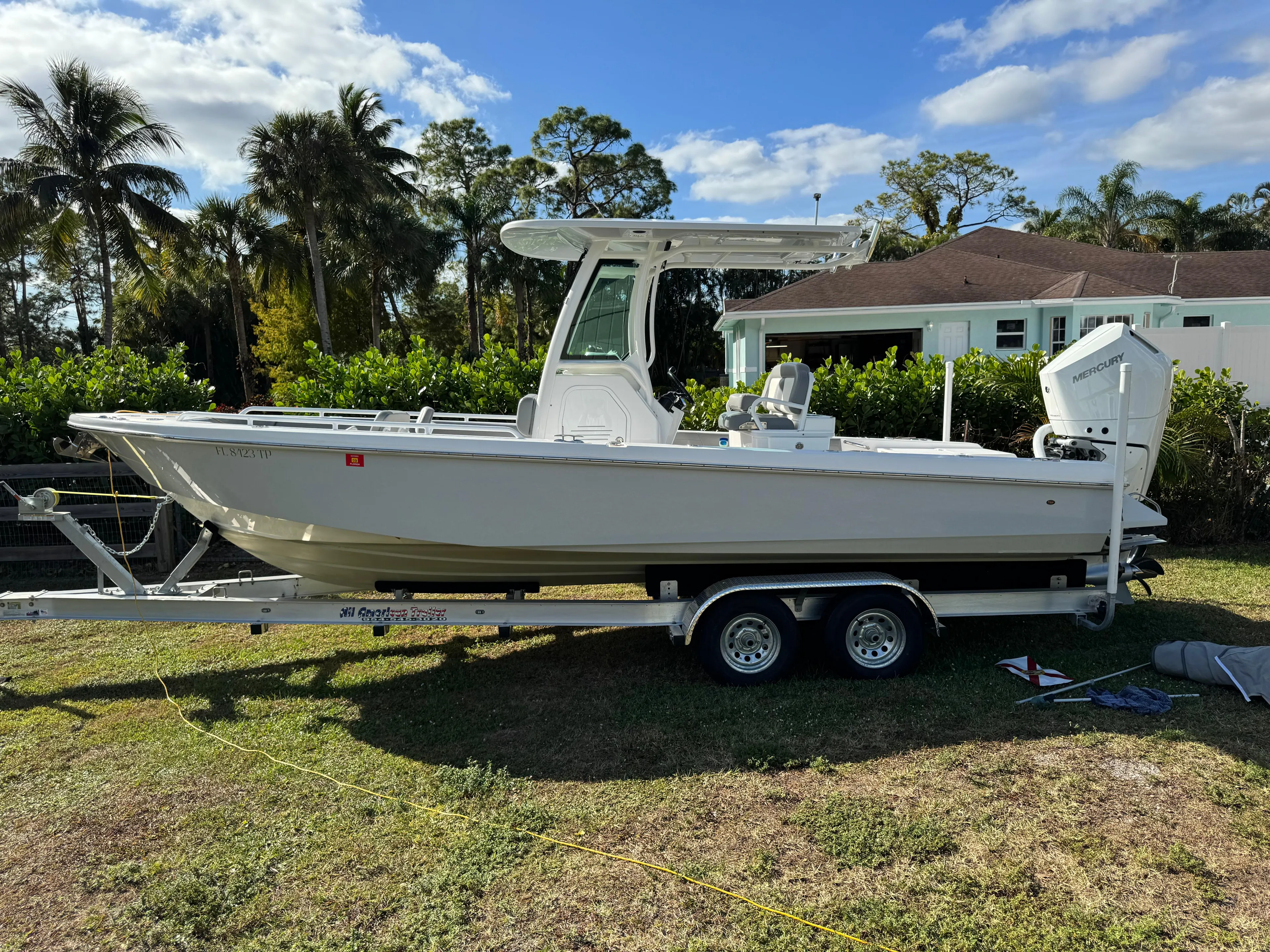 Yacht Photos Pics 2024 Everglades 253 Center Console boat on trailer, parked outdoors.