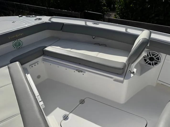  Yacht Photos Pics 2024 Everglades 253 Center Console boat interior with cushioned seating and speaker.