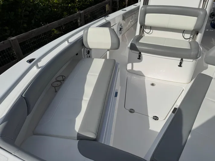  Yacht Photos Pics 2024 Everglades 253 Center Console boat interior with white seating and storage.