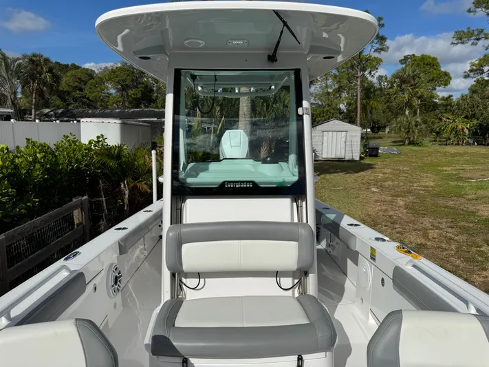  Yacht Photos Pics 2024 Everglades 253 Center Console boat with seating, parked outdoors.