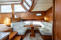 Luxurious interior of 2005 Vripack Spiegelkotter 14.50 yacht with elegant wood and leather seating.