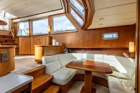 Luxurious interior of 2005 Vripack Spiegelkotter 14.50 yacht with elegant wood and leather seating.