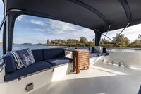 2005 Vripack Spiegelkotter 14.50 yacht deck with seating and table, scenic water view.
