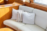Luxurious Vripack Spiegelkotter 14.50 yacht interior with cozy cushions, wood accents, and natural light.