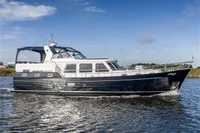 Vripack Spiegelkotter 14.50 yacht, 2005 model, cruising on a calm waterway under a clear sky.