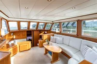 Luxurious interior of 2005 Vripack Spiegelkotter 14.50 yacht with elegant wood finish and plush seating.