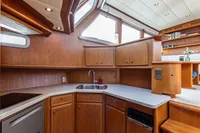 Luxurious kitchen interior of 2005 Vripack Spiegelkotter 14.50 yacht with wooden cabinetry.