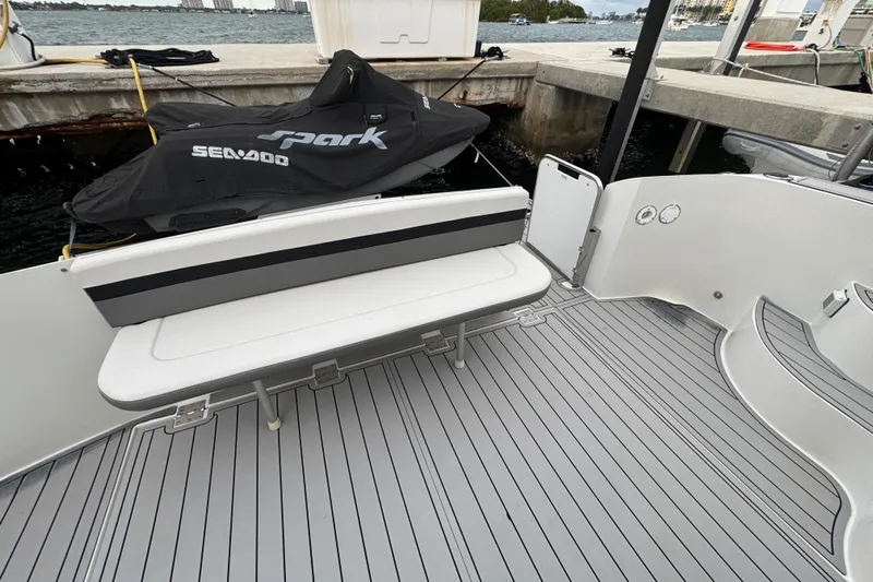  Yacht Photos Pics 2009 Carver 44 Sojourn yacht deck with bench seating and docked Sea-Doo.