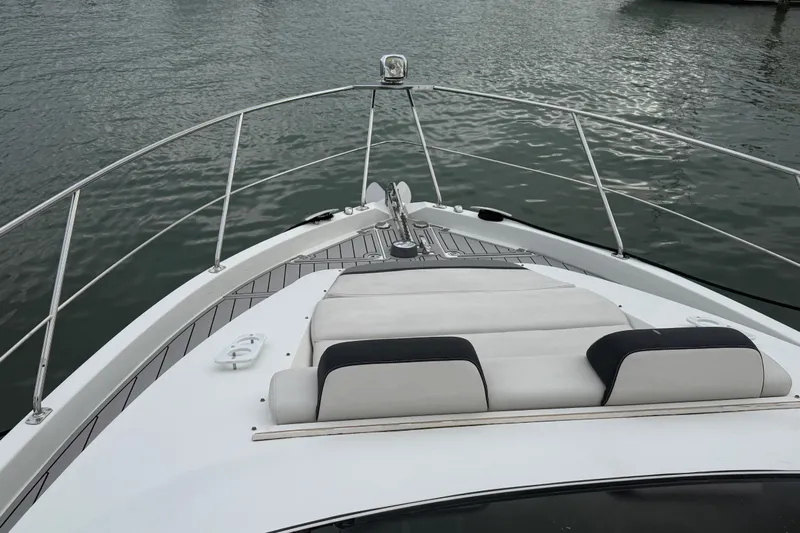  Yacht Photos Pics 2009 Carver 44 Sojourn yacht bow with cushioned seating, on calm water.