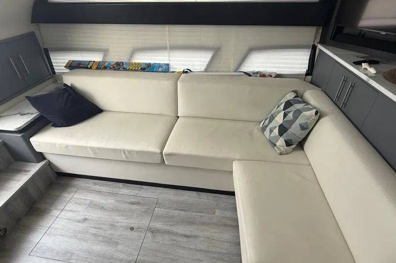  Yacht Photos Pics Luxurious interior of 2009 Carver 44 Sojourn yacht with modern beige seating and geometric pillows.