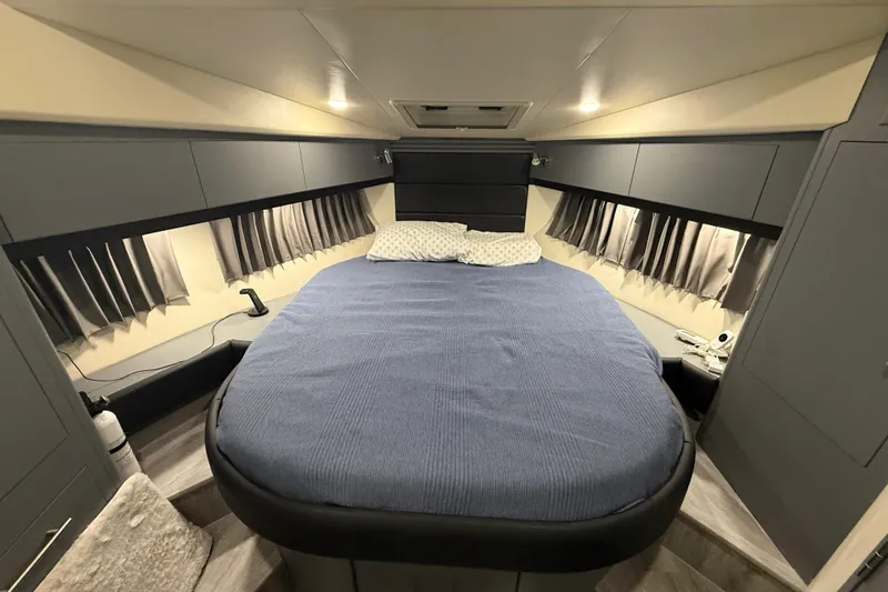  Yacht Photos Pics Luxurious bedroom interior of 2009 Carver 44 Sojourn yacht with cozy bed and modern design.