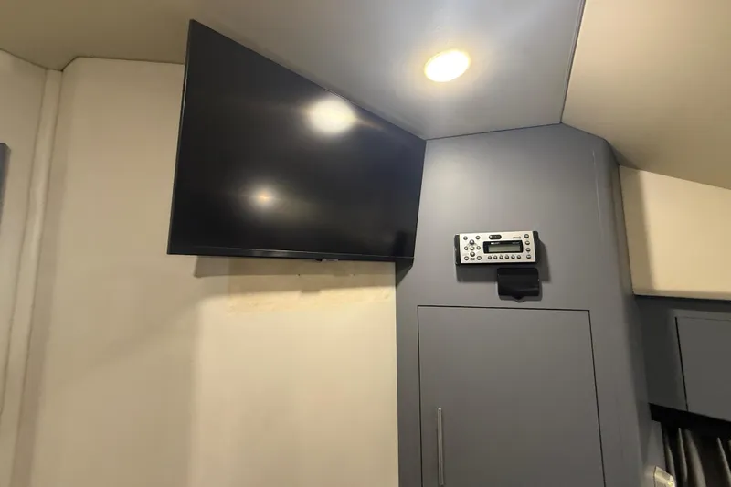  Yacht Photos Pics Interior of 2009 Carver 44 Sojourn with mounted TV and control panel.