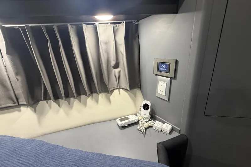  Yacht Photos Pics Interior of 2009 Carver 44 Sojourn with curtain, control panel, and electronic devices.