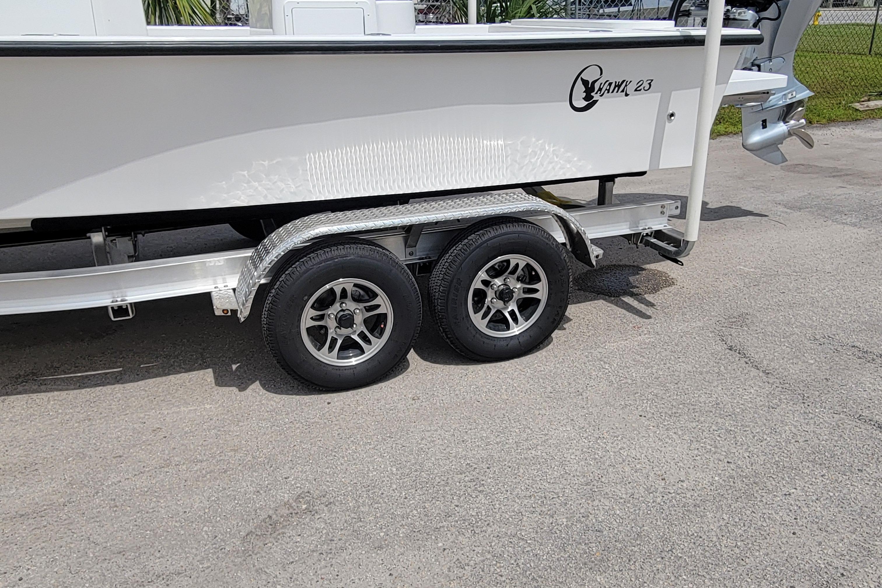 2025 C-Hawk 23CC boat on trailer, featuring dual wheels and sleek design.