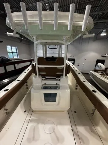  Yacht Photos Pics 2025 Pioneer Pelagic 270 boat interior with rod holders and seating in a showroom.