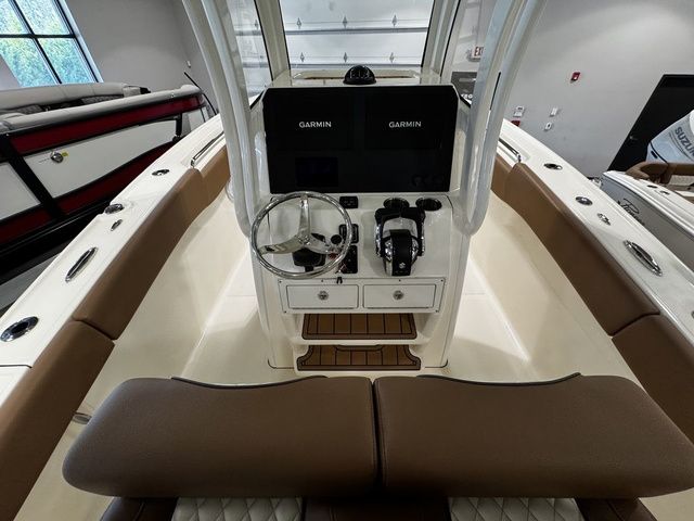 2025 Pioneer Pelagic 270 boat interior with dual Garmin displays and brown seating.