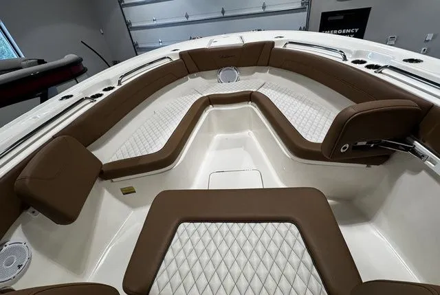 2025 Pioneer Pelagic 270 boat interior with brown cushioned seating and diamond-patterned upholstery.