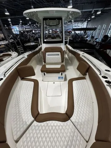  Yacht Photos Pics 2025 Pioneer Pelagic 270 boat interior with brown and white cushioned seating.