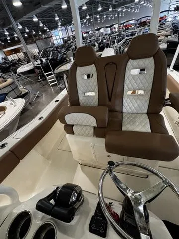  Yacht Photos Pics 2025 Pioneer Pelagic 270 boat interior with brown and white seating in a showroom.