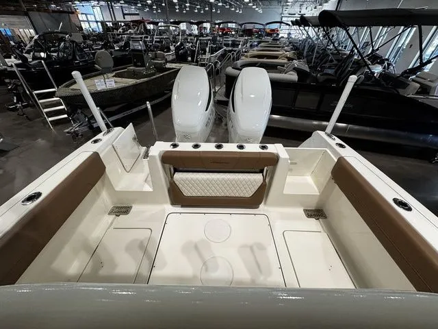  Yacht Photos Pics 2025 Pioneer Pelagic 270 boat interior with twin engines, showcased in a spacious indoor showroom.