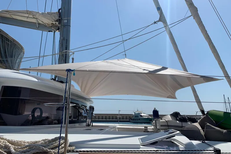  Yacht Photos Pics 2014 Lagoon 560 S2 yacht with sunshade, docked under clear blue sky.