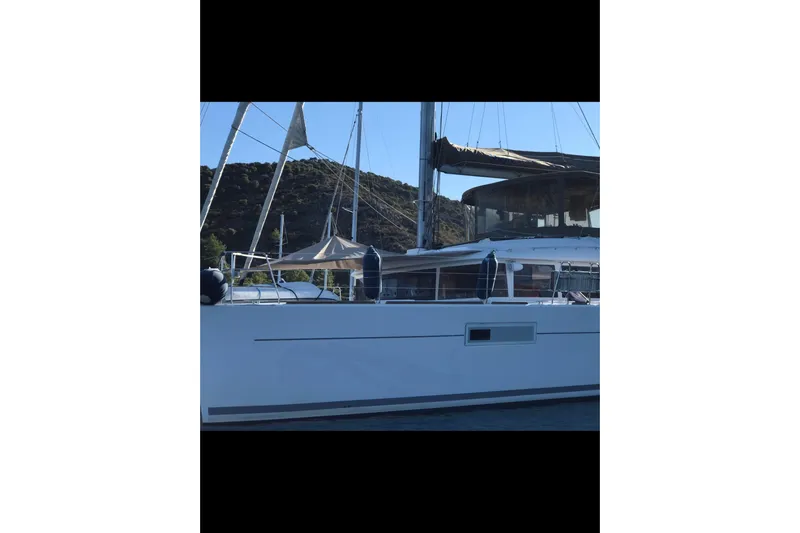  Yacht Photos Pics 2014 Lagoon 560 S2 yacht docked with scenic hillside backdrop.