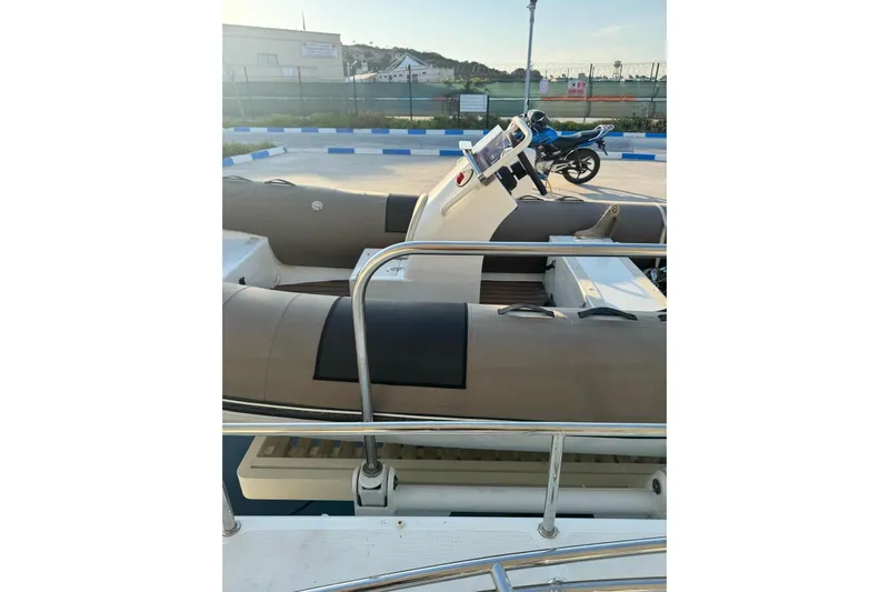 Yacht Photos Pics 2014 Lagoon 560 S2 yacht with inflatable tender docked at marina.