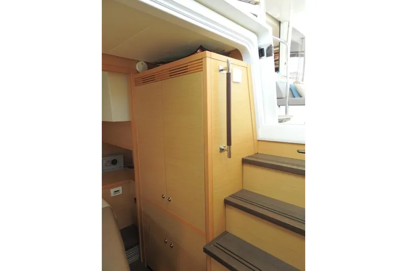  Yacht Photos Pics Interior of 2014 Lagoon 560 S2 yacht with wooden cabinetry and stairs.