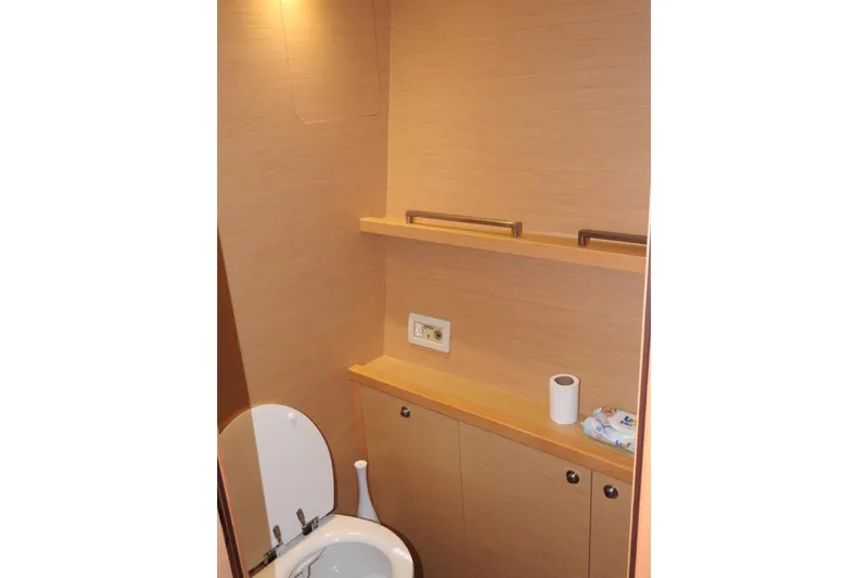  Yacht Photos Pics Bathroom interior of 2014 Lagoon 560 S2 yacht with wooden cabinetry and toilet.