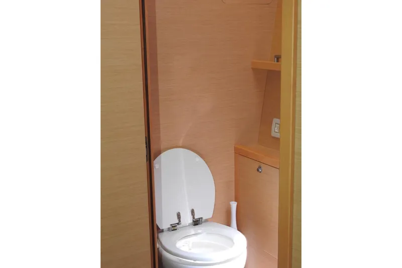  Yacht Photos Pics 2014 Lagoon 560 S2 yacht bathroom with wooden finish and modern toilet.