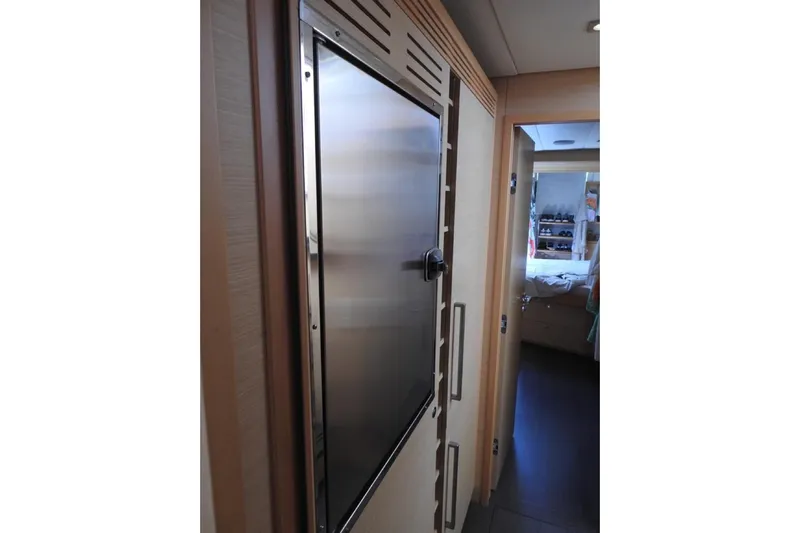  Yacht Photos Pics Interior of 2014 Lagoon 560 S2 yacht, featuring a sleek metal door and cozy cabin.