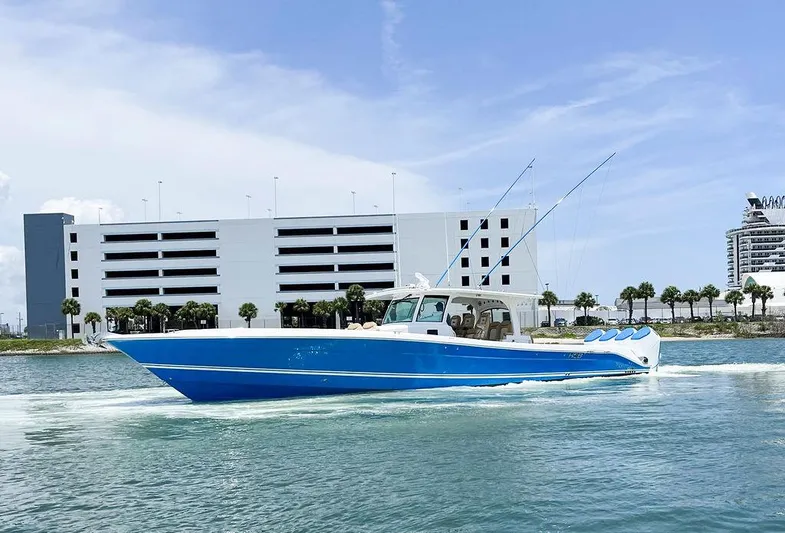 Hcb Yacht Photos Pics 2023 HCB Suenos boat cruising on water near modern buildings.