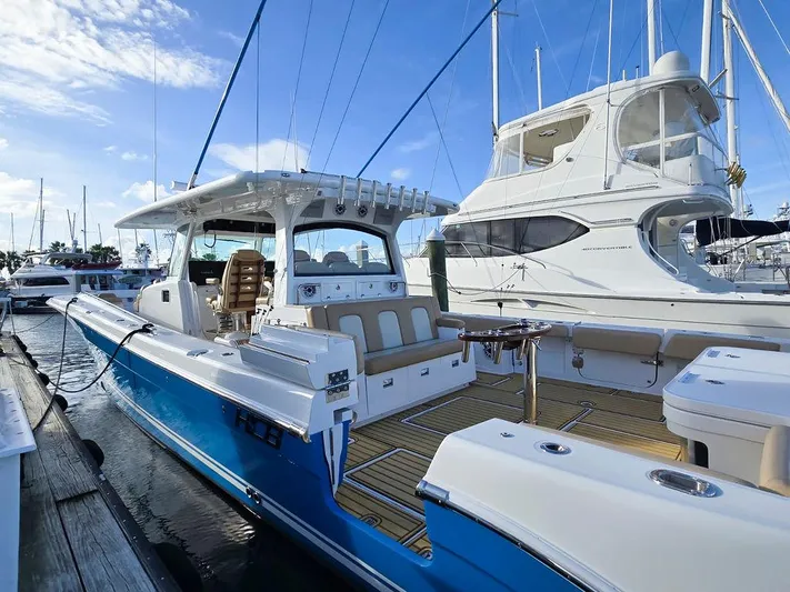 Hcb Yacht Photos Pics 2023 HCB Suenos boat docked in marina, featuring sleek design and spacious seating.