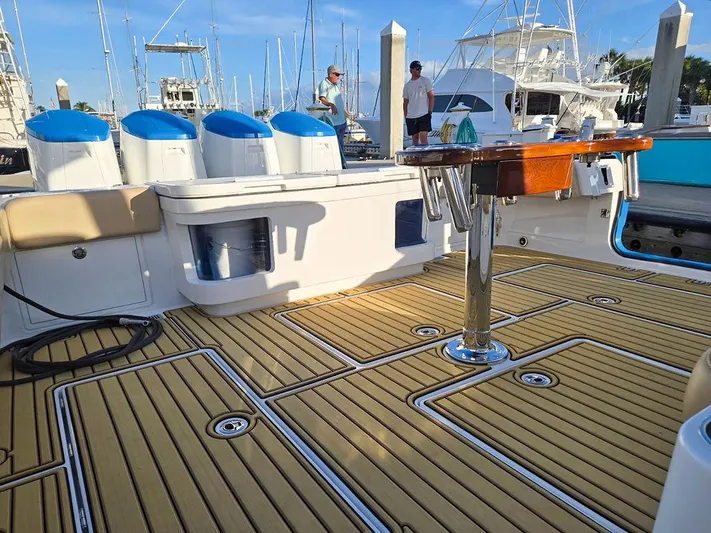 Hcb Yacht Photos Pics 2023 HCB Suenos boat deck with teak flooring and fishing equipment at marina.