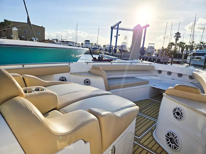 Hcb Yacht Photos Pics 2023 HCB Suenos boat interior with beige seating, docked under bright sunlight.