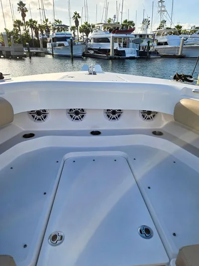 Hcb Yacht Photos Pics 2023 HCB Suenos boat deck with speakers, docked at marina with yachts in background.