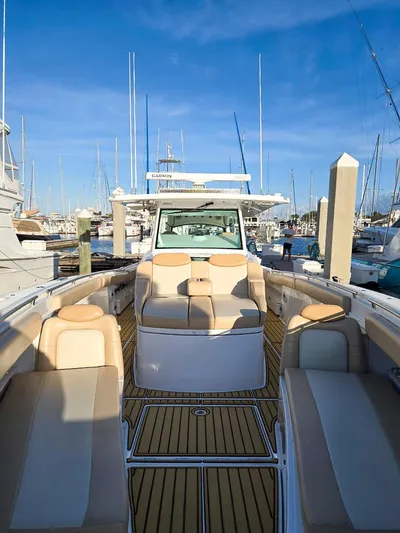 Hcb Yacht Photos Pics 2023 HCB Suenos boat with luxurious seating at a marina.